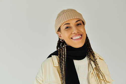 Joyous young woman in fashionable autumn attire posing actively.