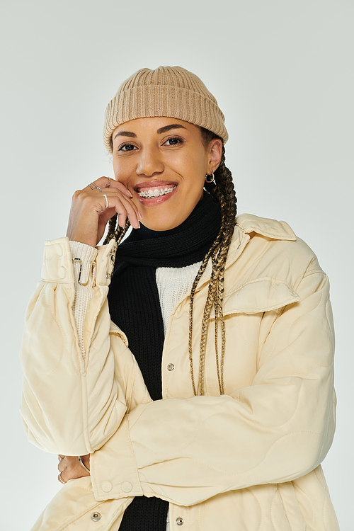 Positive young woman in fashionable autumn attire posing actively.