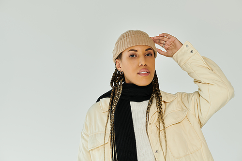 Young african american woman in autumn stylish attire on white backdrop.