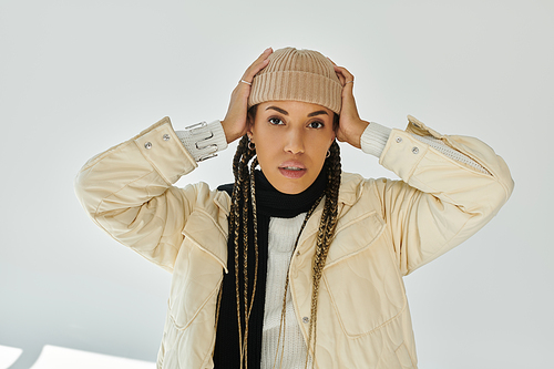 Beautiful african american woman in autumn stylish attire on white backdrop.