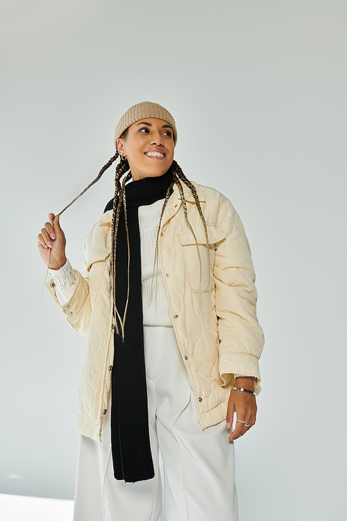 Alluring african american woman in autumn stylish attire on white backdrop.