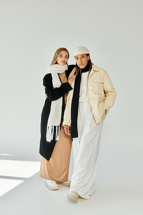 A young couple shares an intimate moment, wearing cozy autumn outfits in soft tones, evoking warmth.