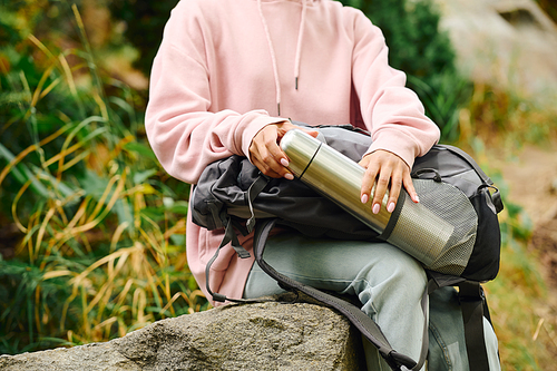 A spirited young woman explores a colorful autumn forest, embracing nature on her hiking adventure.