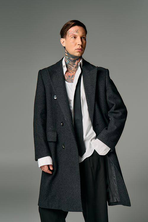 A confident young man displays modern fashion and unique tattoos.