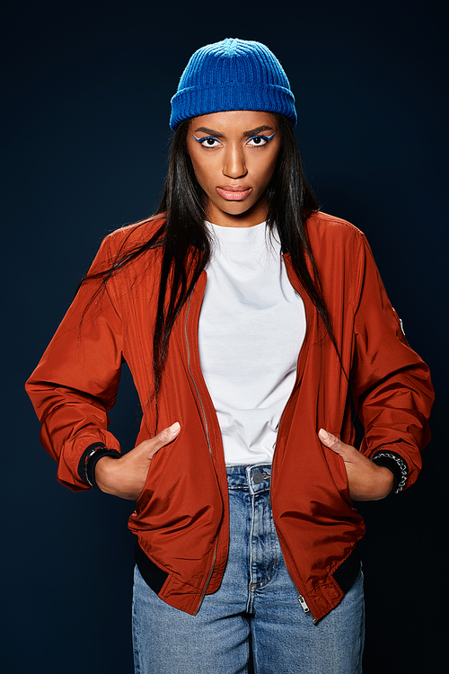 A confident young woman showcases her autumn fashion with a striking look and vibrant colors.