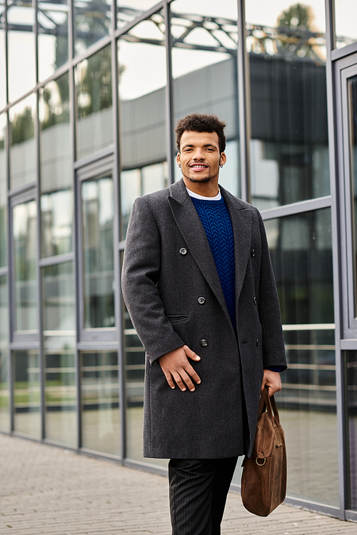 Stylish man with a confident smile strolls through a contemporary cityscape carrying a bag