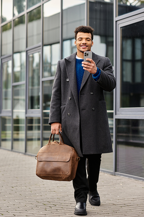 A stylish man strolls through a modern urban area, engaged with his phone and exuding charm.