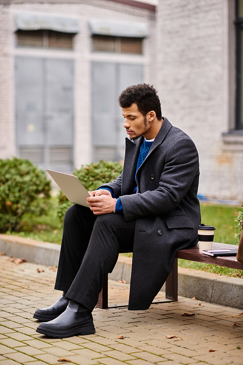 Concentrated individual using a laptop outdoors, embracing the serenity of nature in autumn.