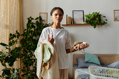 A young African American woman organising her home