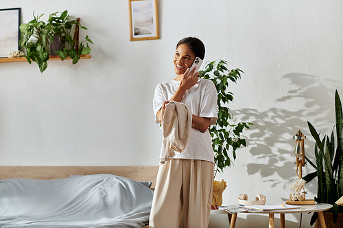 Bright and neat apartment where a young woman is engaged in her house cleaning chores.