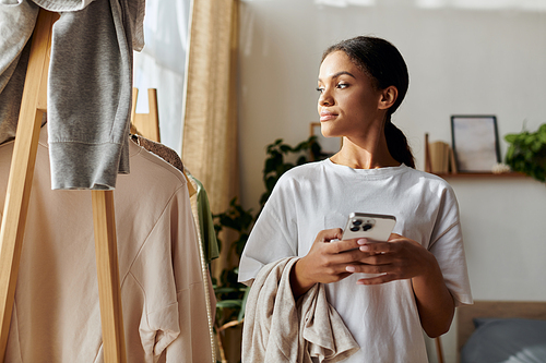 A young African American woman focuses on her cleaning tasks in a stylish apartment.