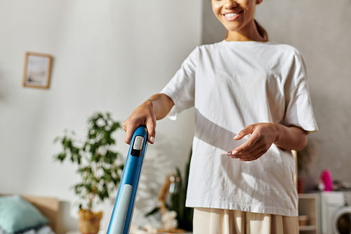 Young woman tidies her modern apartment, enjoying the process of cleaning at home