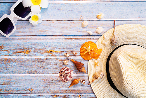 Beautiful summer holiday, Beach accessories, sunglasses, hat and shells on wooden backgrounds