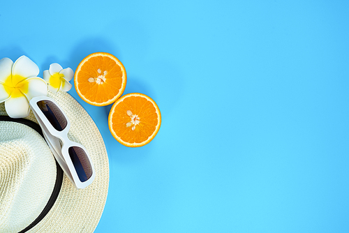 Beautiful summer holiday, Beach accessories, sunglasses, hat and orange on blue backgrounds
