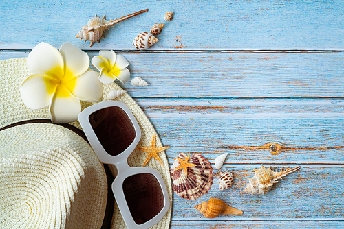 Beautiful summer holiday, Beach accessories, sunglasses, hat and shells on wooden backgrounds