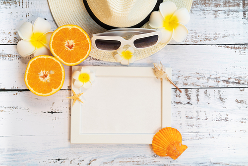 Beautiful summer holiday, Beach accessories, orange, sunglasses, hat and shells on wooden backgrounds