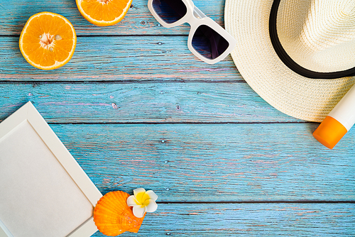 Beautiful summer holiday, Beach accessories, orange, sunglasses, hat and sunblock on wooden backgrounds