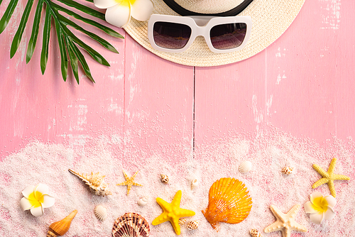 Beautiful summer holiday, Beach accessories, seashells, sand, hat, sunglasses and palm leave on wooden backgrounds