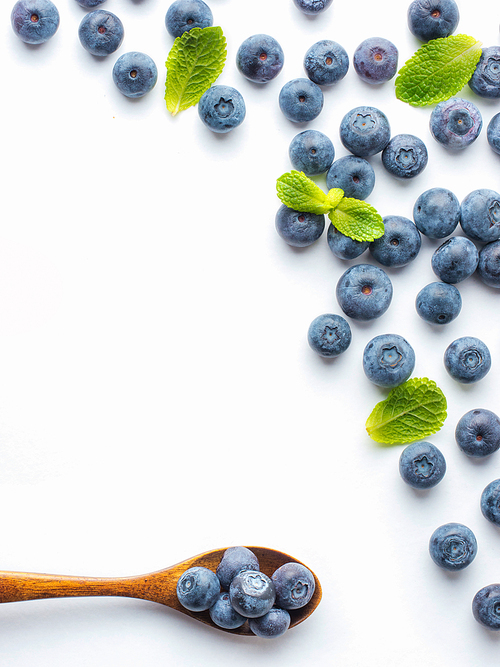 Blueberries isolated on white. Blueberry border design. Ripe and juicy fresh picked bilberries close up. Copyspace. Top view or flat lay