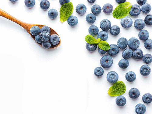 Blueberries isolated on white. Blueberry border design. Ripe and juicy fresh picked bilberries close up. Copyspace. Top view or flat lay