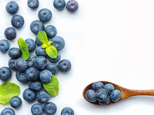 Blueberries isolated on white. Blueberry border design. Ripe and juicy fresh picked bilberries close up. Copyspace. Top view or flat lay