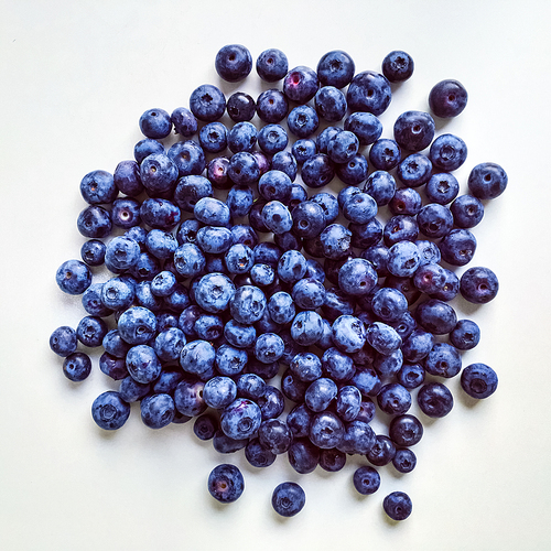 Big ripe blueberries isolated on white.