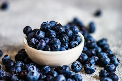 Organic food concept with ripe blueberry on rusty stone background