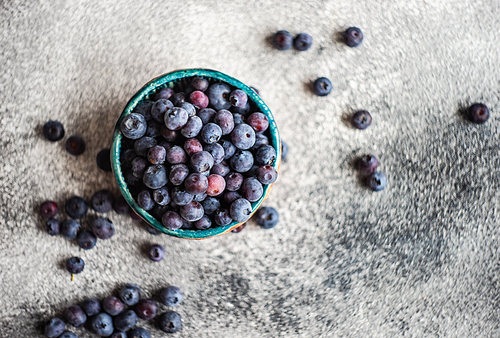 Organic food concept with ripe blueberry on rusty stone background