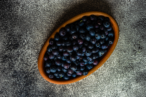 Organic food concept with ripe blueberry on rusty stone background