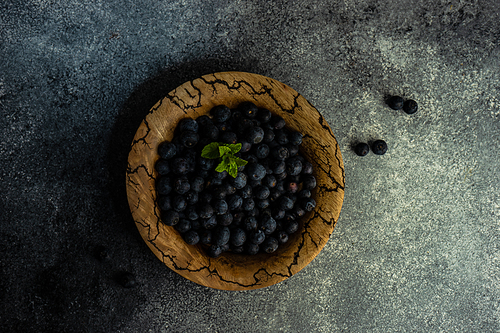 Organic blueberry fruits on concrete background with copy space