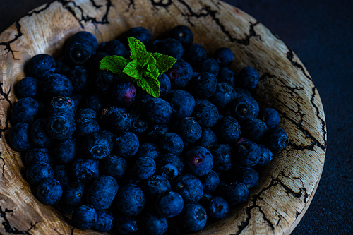 Organic blueberry fruits on concrete background with copy space