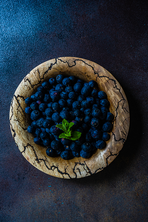 Organic blueberry fruits on concrete background with copy space