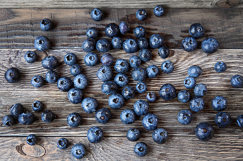 Blueberry lie on wooden background. Rustic cozy background with healthy food. Fresh-gathered berries full of vitamins, good for diet nutrition and healthy meals.