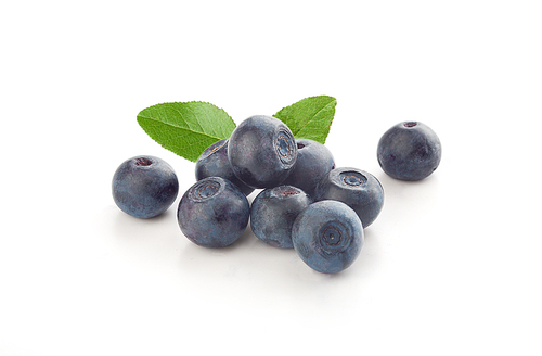 Handful of fresh blueberry with green leaves