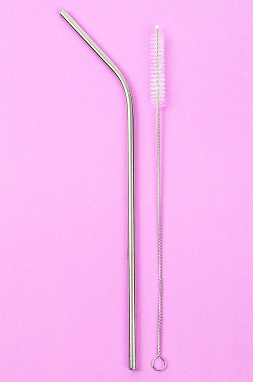 reusable stainless steel straws and cleaning brush on pink background,  friendly lifestyle