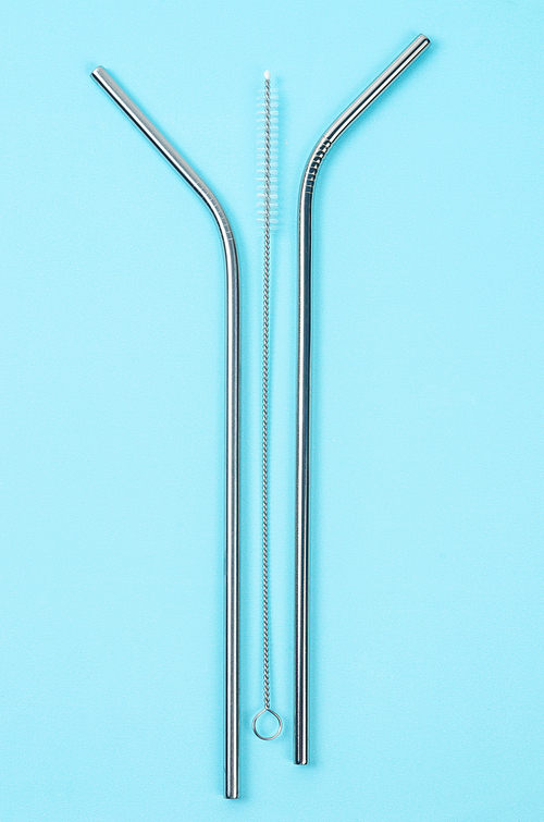 reusable stainless steel straws and cleaning brush on blue background,  friendly lifestyle