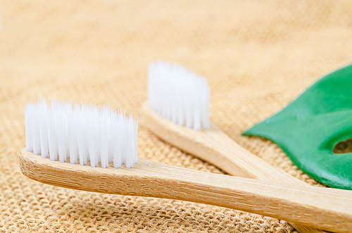 Bamboo toothbrushes on sack backgroud.