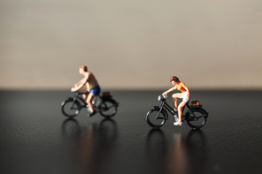 Miniature people : Travelers riding bicycle , Healthy lifestyle concept