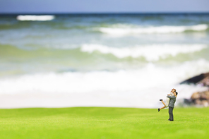 Miniature couple on the beach background