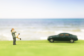 Miniature couple on the beach background