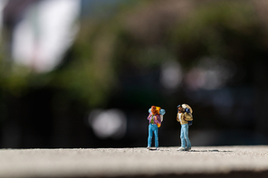 Miniature people :  Traveler with backpack standing on The road . Travel Concept