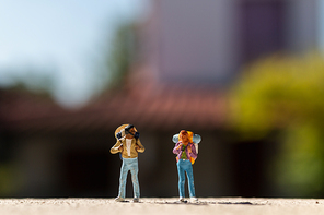 Miniature people :  Traveler with backpack standing on The road . Travel Concept