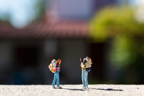 Miniature people :  Traveler with backpack standing on The road . Travel Concept