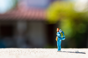 Miniature people :  Traveler with backpack standing on The road . Travel Concept