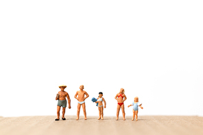 Miniature people wearing swimsuit standing on the beach  , vacation concept