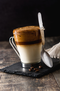 Creamy iced dalgona coffee on wooden table