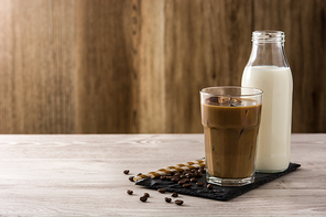 Iced coffee or caffe latte on wooden table