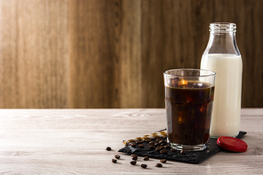 Iced coffee or caffe latte on wooden table