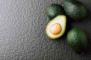 Avocado on old wooden table.