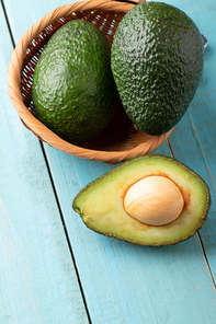 Avocado on old wooden table.